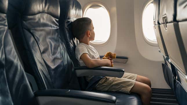 Child sitting alone on an airplane