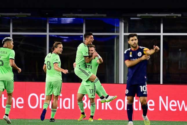 Sep 2, 2023; Foxborough, Massachusetts, USA;  Austin FC midfielder Emiliano Rigoni (7) celebrates his goal by jumping to the arms of midfielder Jon Gallagher (17) during the first half at Gillette Stadium.
