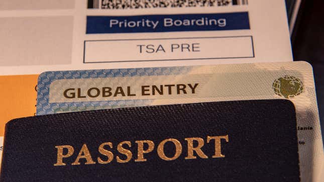 stack of a passport, global entry account and TSA pre-check boarding pass