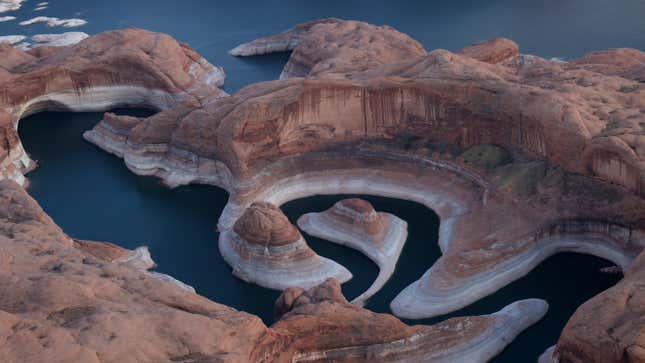 The tall bleached "bathtub ring" is visible on the rocky banks of Lake Powell at Reflection Canyon on June 24, 2021 in Lake Powell, Utah.