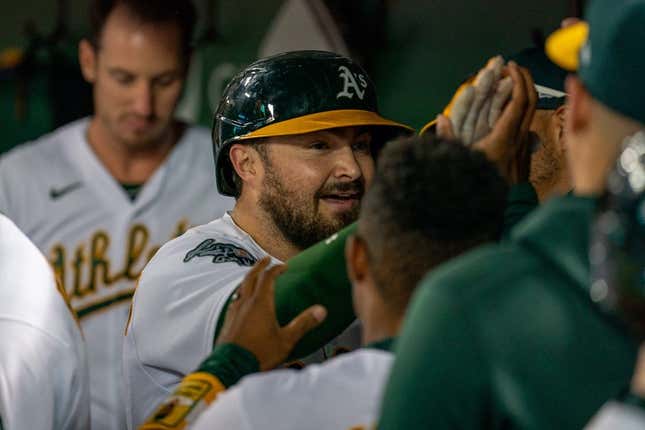 Aug 21, 2023; Oakland, California, USA;  Oakland Athletics catcher Shea Langeliers (23) celebrates with teammates in the dugout after hitting a solo homer against the Kansas City Royals during the sixth inning at Oakland-Alameda County Coliseum.