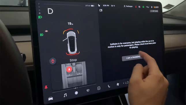 The message that pops up when you shift into drive while Solitaire is running in a Tesla Model 3.
