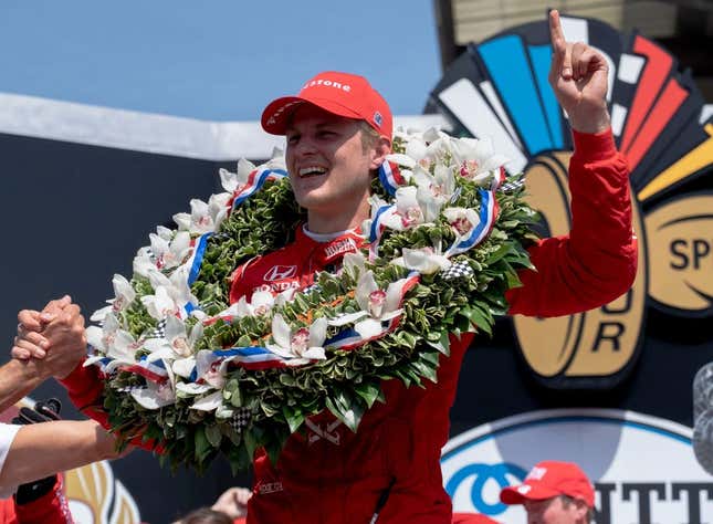 May 29, 2022; Indianapolis, IN, USA;  Chip Ganassi Racing driver Marcus Ericsson (8) celebrates on the podium with the milk after winning the 106th running of the Indianapolis 500 at Indianapolis Motor Speedway.