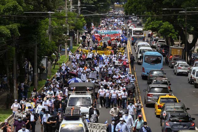 People take part in a demonstration against the Salvadoran government’s bitcoin gamble in San Salvador, on September 7, 2021.