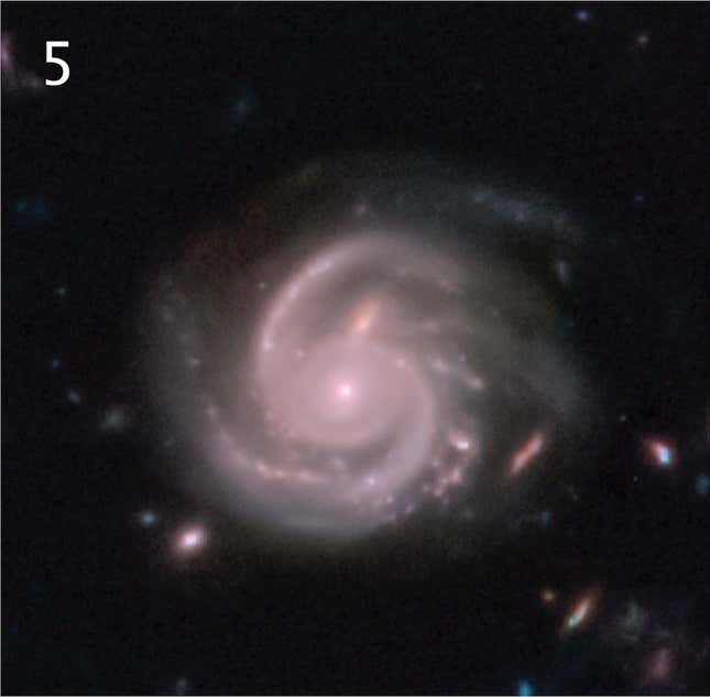 A pinkish spiral galaxy, its arms outstretched like a whirlpool.