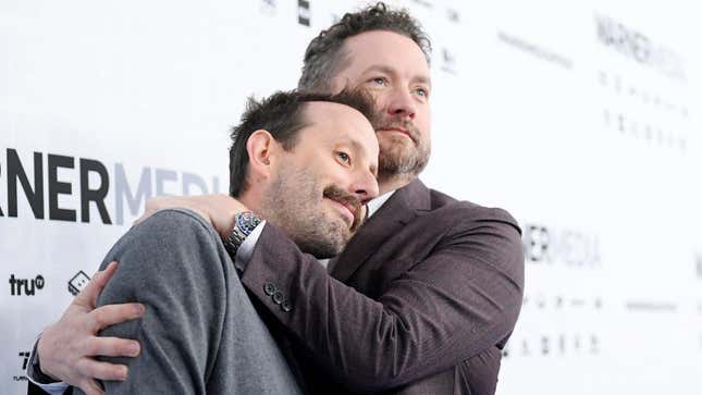 Rooster Teeth co-founders Burnie Burns and Geoff Ramsey embrace at a Warner Bros. event in 2019.