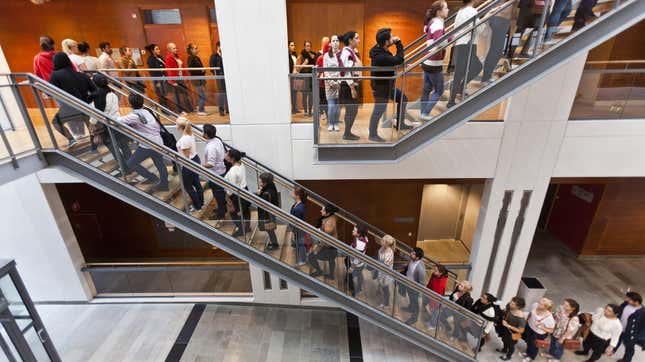 long line of people on a stair case in an office building