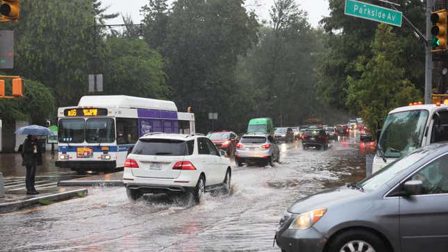 Cars drive through slight flooding on Ocean Avenue amid heavy rain on September 29, 2023 in the Flatbush neighborhood of Brooklyn borough New York City.