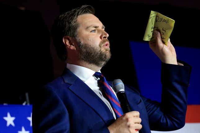 Republican Senate candidate JD Vance holds a piece of paper with the name of former President Donald Trump written on it, as he speaks May 3, 2022, in Cincinnati.