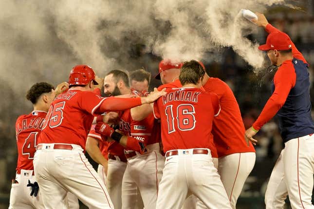 Jul 17, 2023; Anaheim, California, USA;  Los Angeles Angels second baseman Michael Stefanic (38) is mobbed after a pinch hit RBI single in the 10th inning to defeat the New York Yankees at Angel Stadium.