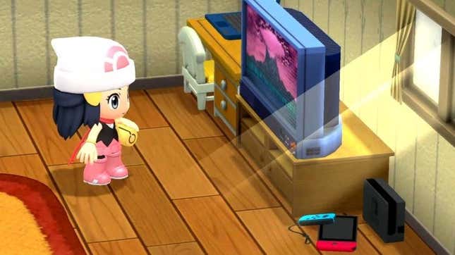 A Pokemon trainer sits in her room looking at a TV. 
