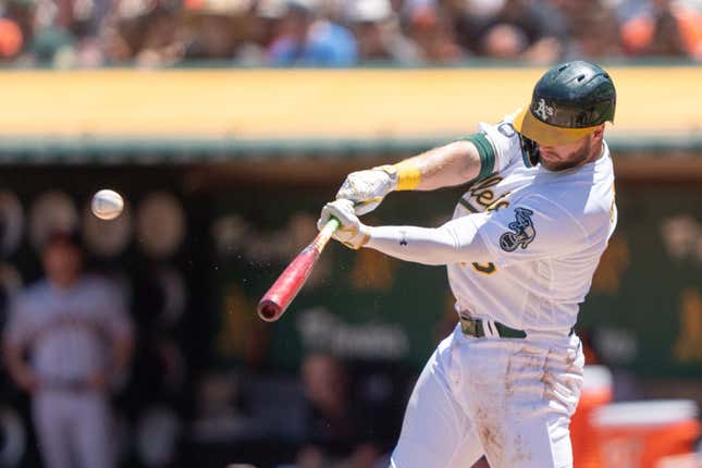 Aug 6, 2023; Oakland, California, USA;  Oakland Athletics left fielder Seth Brown (15) hits an RBI triple during the first inning against the San Francisco Giants at Oakland-Alameda County Coliseum.