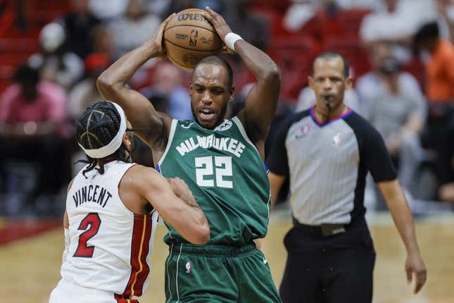 Apr 22, 2023; Miami, Florida, USA; Milwaukee Bucks forward Khris Middleton (22) protects the basketball from Miami Heat guard Gabe Vincent (2) in the third quarter during game three of the 2023 NBA Playoffs at Kaseya Center.