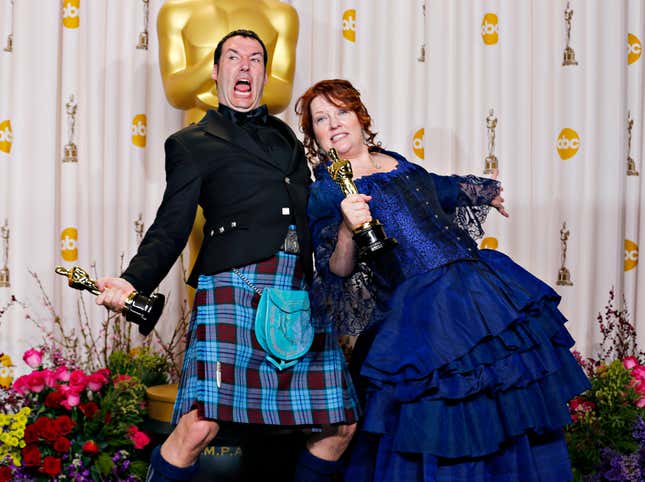 Mark Andrews (L) and Brenda Chapman (R) strike a pose with their Oscar for best animated feature film for "Brave."