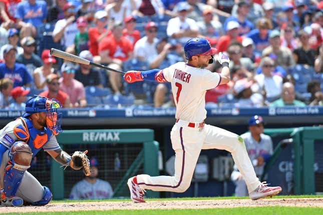 Jun 25, 2023; Philadelphia, Pennsylvania, USA; Philadelphia Phillies shortstop Trea Turner (7) hits an RBI single against the New York Mets during the third inning at Citizens Bank Park.