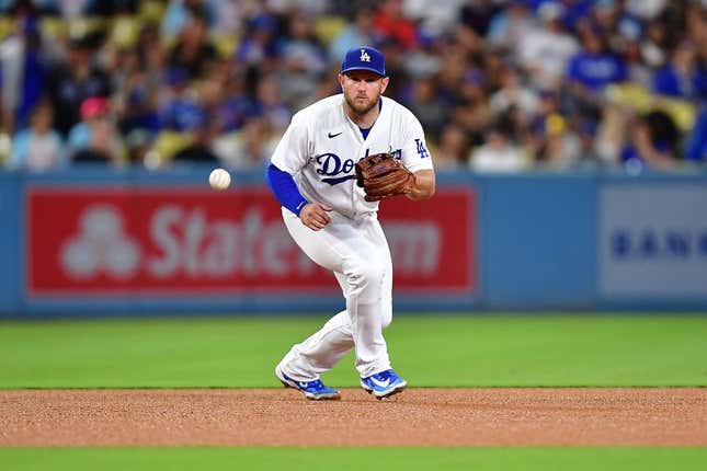 Aug 15, 2023; Los Angeles, California, USA; Los Angeles Dodgers third baseman Max Muncy (13) fields the ground ball of Milwaukee Brewers designated hitter Mark Canha (21) during the fifth inning at Dodger Stadium.