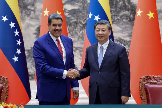 In this photo released by Xinhua News Agency, visiting Venezuela&#39;s President Nicolas Maduro, left, shakes hands with his Chinese counterpart Xi Jinping during a meeting at the Great Hall of the People in Beijing, Wednesday, Sept. 13, 2023. (Liu Bin/Xinhua via AP)
