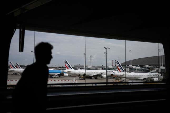 A traveller walks in the Terminal 2 corridors of the Roissy-Charles de Gaulle airport, in the northeastern outskirts of Paris, on September 16, 2022, amid a strike of air traffic controllers. At least one thousand flights have been cancelled as a consequence of the strike called by the SNCTA air controller union, also disturbing the European air traffic, according to the DGAC