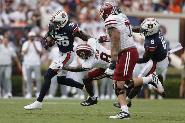 Sep 2, 2023; Auburn, Alabama, USA;  Massachusetts Minutemen wide receiver Anthony Simpson (8) moves in to tackle Auburn Tigers cornerback Jaylin Simpson (36) after Simpson recovered a fumble during the second quarter at Jordan-Hare Stadium.