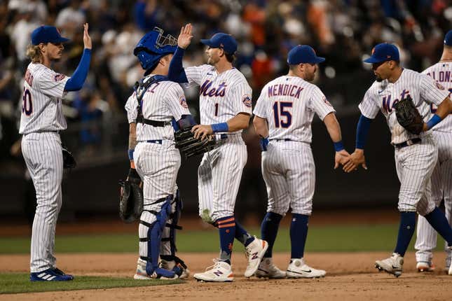 Aug 9, 2023; New York City, New York, USA; New York Mets second baseman Jeff McNeil (1) high fives teammates after defeating the Chicago Cubs at Citi Field.