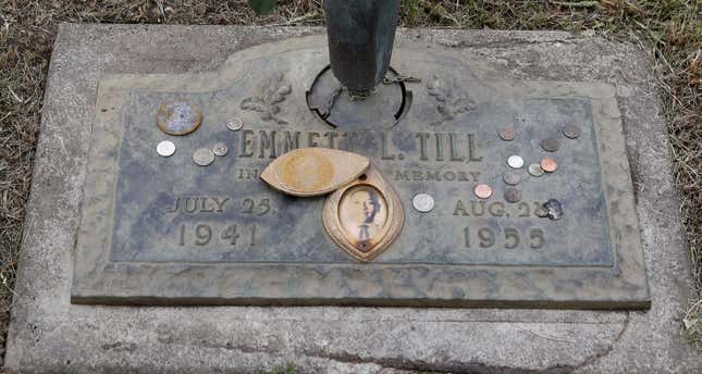 The grave marker of Emmett Till has a photo of Till and coins placed on it during a gravesite ceremony at the Burr Oak Cemetery marking the 60th anniversary of the murder of Till in Mississippi, Friday, Aug. 28, 2015, in Alsip, Ill.
