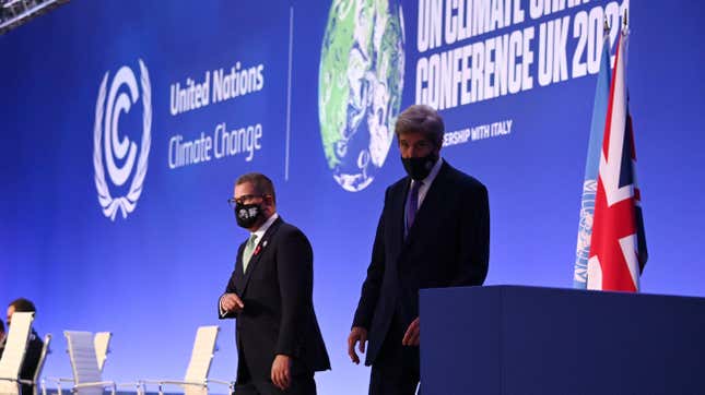 U.S. Special Presidential Envoy for Climate John Kerry (R) with COP26 President Alok Sharma walking off stage.