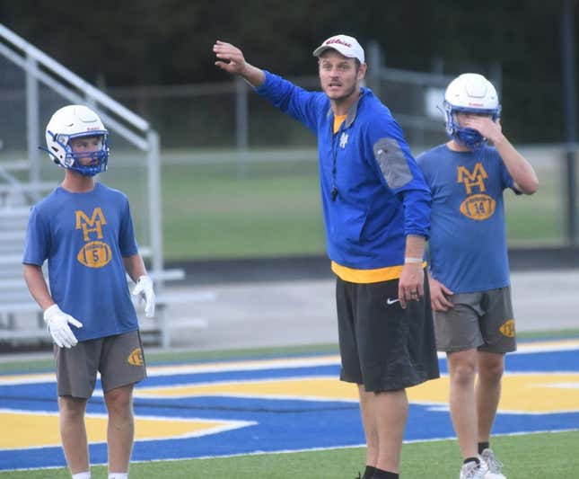 Mountain Home assistant coach Ryan Mallett gives instructions during a recent practice as Bombers Dillon Drewry (left) and Daxton Hickman (right) listen at Bomber Stadium. Fans must buy tickets in advance to attend the Bombers&#39; scrimmage on Thursday against Highland. No tickets will be sold at the gate.

Dsc 6234