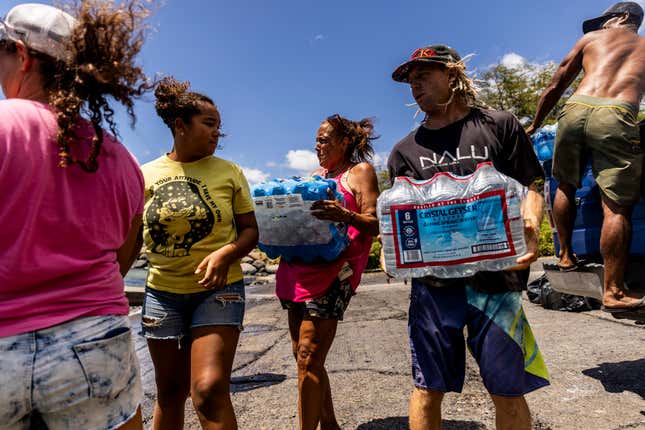Volunteers load supplies onto a boat for West Maui at the Kihei boat landing, after a wildfire destroyed much of the historical town of Lahaina, on the island of Maui, Hawaii on Sunday, August. 13, 2023.