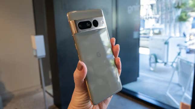 A Google Pixel 7 Pro held up in front of a window.