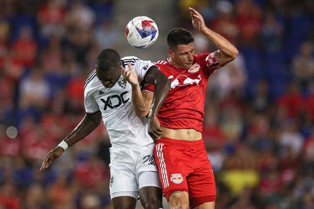 Aug 20, 2023; Harrison, New Jersey, USA; New York Red Bulls defender Sean Nealis (15) battles D.C. United forward Christian Benteke (20) for a high ball during the first half at Red Bull Arena.