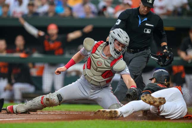Jun 28, 2023; Baltimore, Maryland, USA; Cincinnati Reds catcher Tyler Stephenson (37) tags out Baltimore Orioles third baseman Gunnar Henderson (2) attempting to score at home plate during the first inning at Oriole Park at Camden Yards.