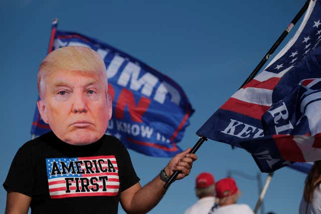 A supporter of former U.S. President Donald Trump attends a gathering outside his Mar-a-Lago resort after he posted a message on his Truth Social account saying that he expects to be arrested on Tuesday, and called on his supporters to protest, in Palm Beach, Florida, U.S. March 21, 2023.