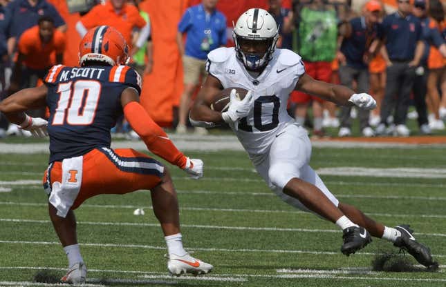 Sep 16, 2023; Champaign, Illinois, USA;  Penn State Nittany Lions running back Mehdi Flowers (right) runs the ball against Illinois Fighting Illini defensive back Miles Scott (10) during the first half at Memorial Stadium.