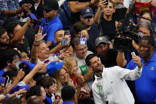 Sep 10, 2023; Flushing, NY, USA; Novak Djokovic of Serbia takes a selfie with fans after his match against Daniil Medvedev (not pictured) in the men&#39;s singles final in the men&#39;s singles final on day fourteen of the 2023 U.S. Open tennis tournament at USTA Billie Jean King National Tennis Center.