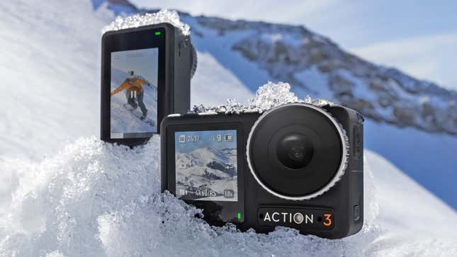 Two DJI Osmo Action 3 action cameras sitting on the snow-covered side of a mountain.