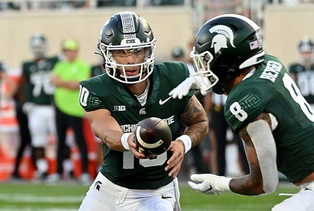 Sep 1, 2023; East Lansing, Michigan, USA;  Michigan State Spartans quarterback Noah Kim (10) hands the ball to Michigan State Spartans running back Jalen Berger (8) against the Central Michigan Chippewas at Spartan Stadium.