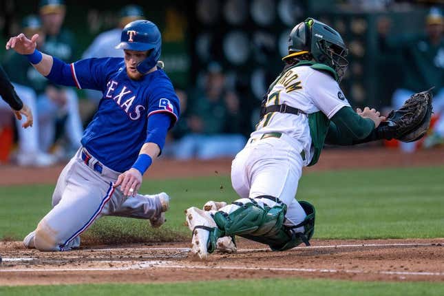 Aug 8, 2023; Oakland, California, USA;  Texas Rangers catcher Sam Huff (55) scores on a single hit by Texas Rangers second baseman Marcus Semien (not pictured) against the Oakland Athletics during the fourth inning at Oakland-Alameda County Coliseum.