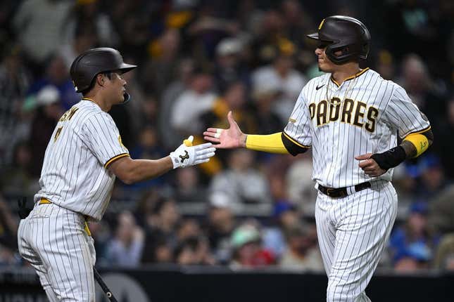 Jun 5, 2023; San Diego, California, USA; San Diego Padres third baseman Manny Machado (13) is congratulated by shortstop Ha-seong Kim (7) after scoring a run against the Chicago Cubs during the eighth inning at Petco Park.