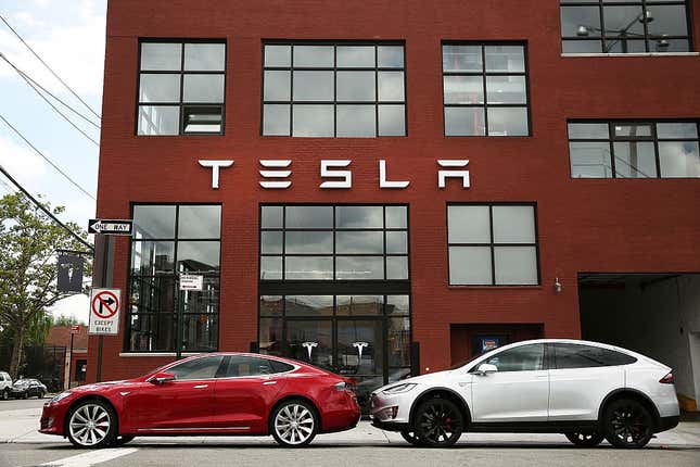 Tesla vehicles sit parked outside of a new Tesla showroom and service center in Red Hook, Brooklyn,on July 5, 2016, in New York City. 