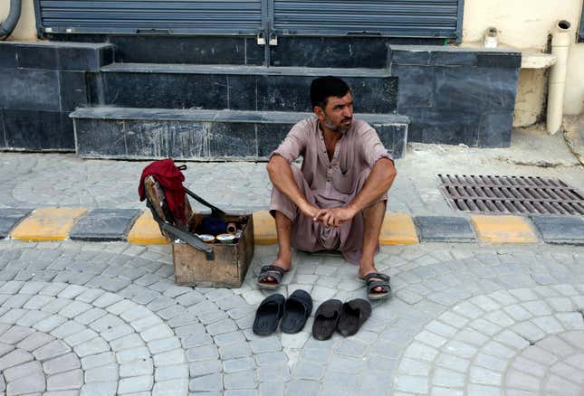 A cobbler waits for customers, as the shopkeepers closed their businesses during a strike against inflation in Peshawar, Pakistan, Saturday, Sept. 2, 2023. Pakistani traders on Saturday went on strike against the soaring cost of living, including higher fuel and utility bills and record depreciation of the rupee against the dollar, which has led to widespread discontent among the public. (AP Photo/Muhammad Sajjad)