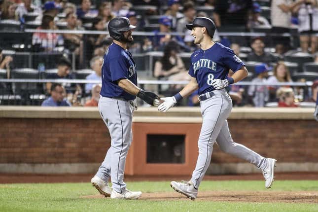 Sep 2, 2023; New York City, New York, USA;  Seattle Mariners pinch hitter Dominic Canzone (8) is greeted by Seattle Mariners pinch runner Mike Ford (20) after hitting a two run home run in the sixth inning against the New York Mets at Citi Field.