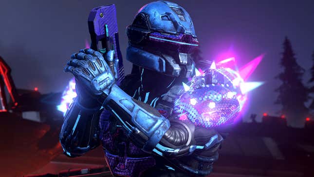 A Spartan holds up a pistol while sporting glowing armor.