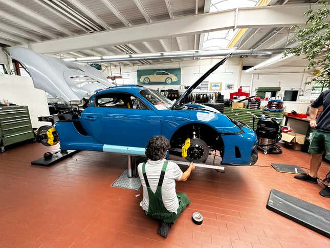 A Ruf technician works on a bright blue CTR3