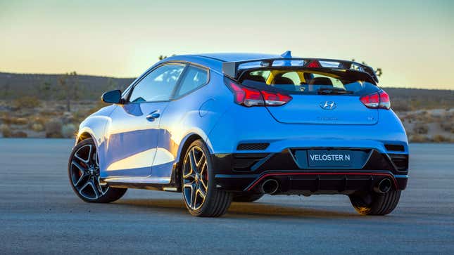 A photo of a pale blue Hyundai Veloster N at sunset. 