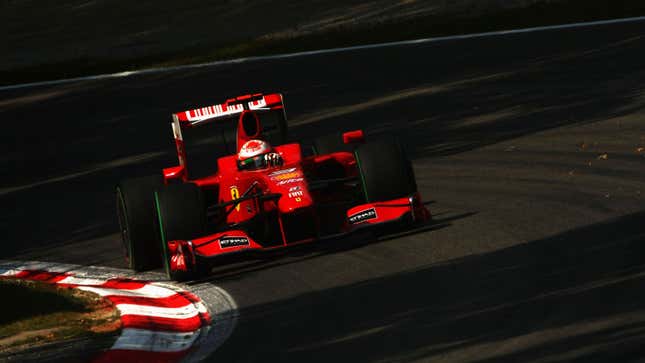 A photo of Giancarlo Fisichella driving his red Ferrari F1 car at the Italian Grand Prix. 