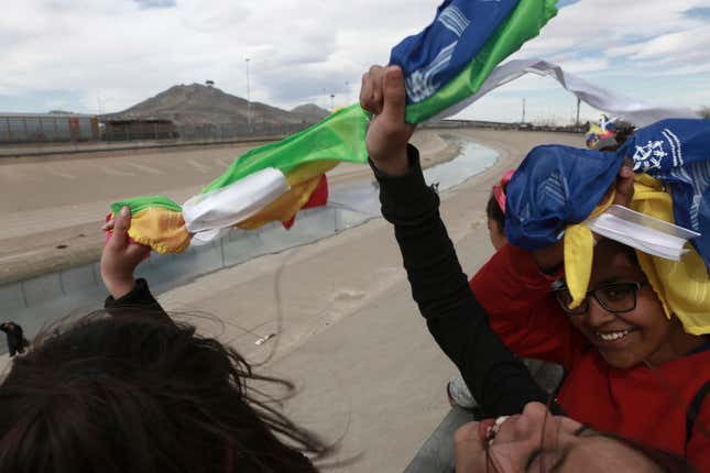 Image for article titled To protest Trump, Mexicans locked arms to form a friendly human wall along the US border