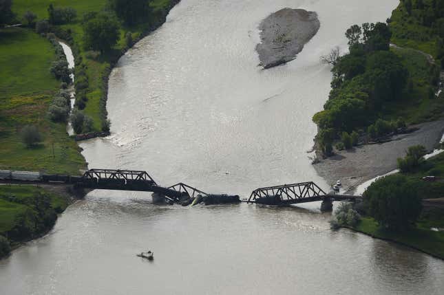 Portions of a freight train are seen in the Yellowstone River after an overnight railroad bridge collapse, near Columbus, Montana, on Saturday, June 24, 2023.