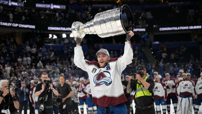 Colorado Avalanche right wing Mikko Rantanen (96) lifts the Stanley Cup after the team defeated the Tampa Bay Lightning in Game 6 of the NHL hockey Stanley Cup Finals on Sunday, June 26, 2022, in Tampa, Fla. (AP Photo/Phelan M. Ebenhack)