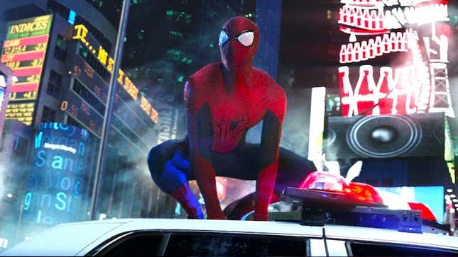 Andrew Garfield's Spider-Man crouches atop a police car in Times Square, in a scene from The Amazing Spider-Man 2.