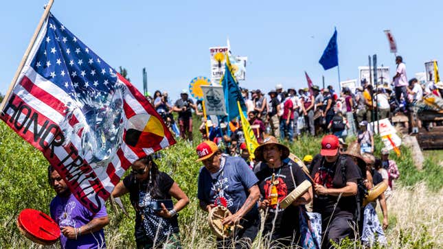 Indigenous climate activists march to the pipeline construction water crossing section after praying for water during a rally and march in Solway, Minnesota on June 7, 2021.